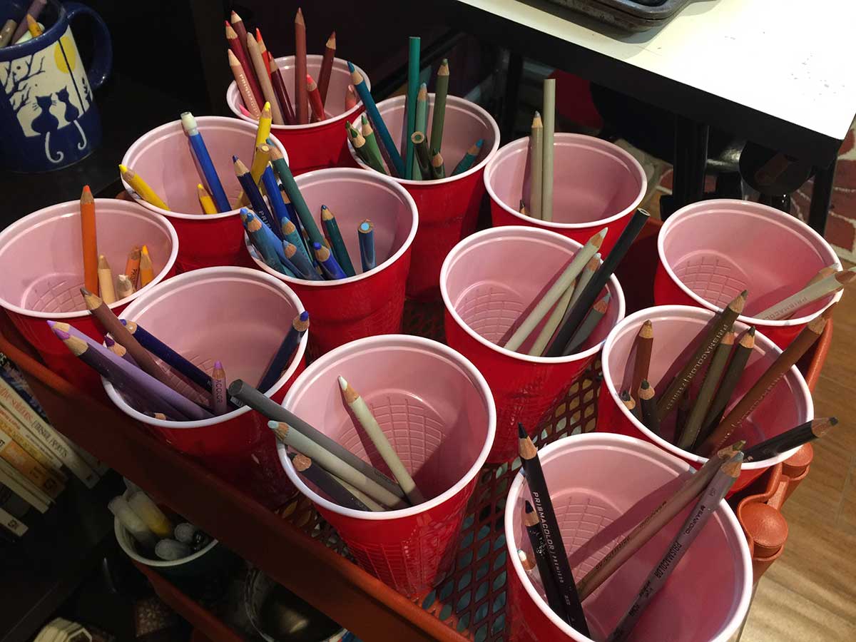 Red solo cups are great for organizing colored pencils by color.